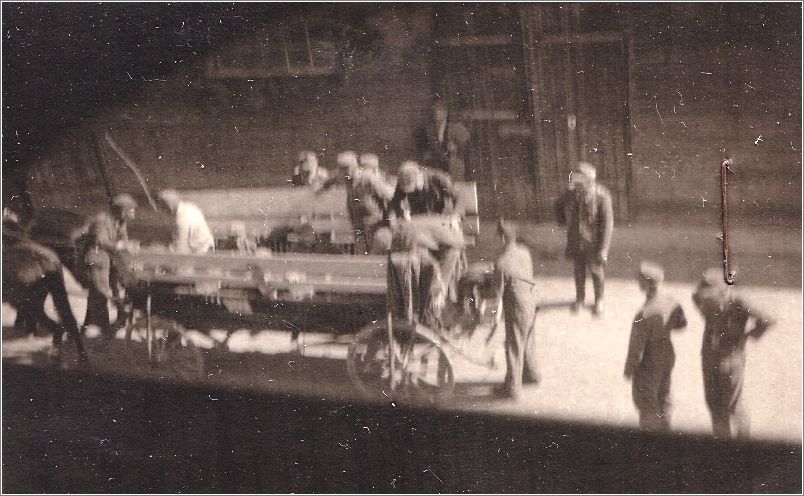 SS men oversee inmates stacking corpses at Mauthausen
